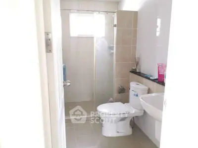 Modern bathroom with glass shower and sleek fixtures in a bright, airy space.