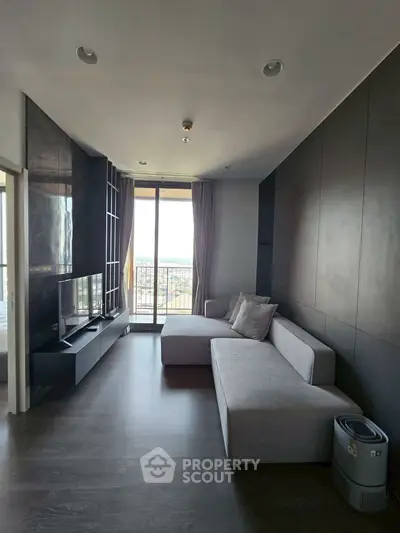 Modern living room with sleek design and balcony view in a stylish apartment.