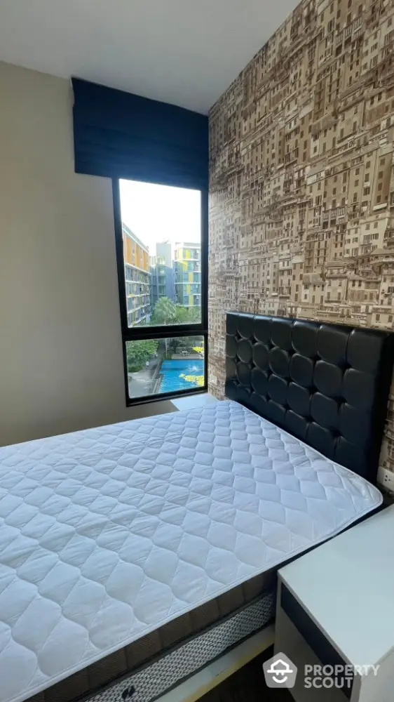 Modern bedroom with cityscape wallpaper and pool view from window