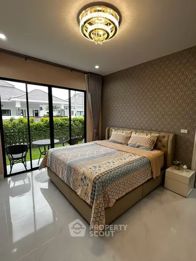 Elegant bedroom with garden view and modern decor in luxury home