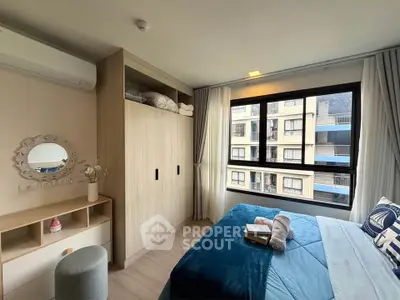 Modern bedroom with large window and stylish decor in urban apartment