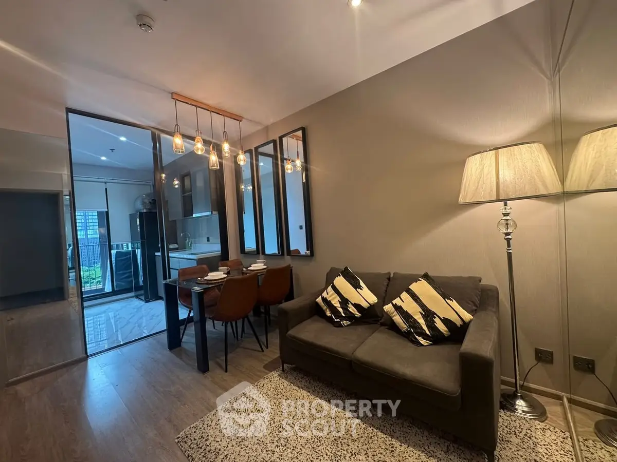 Modern living room with cozy sofa and stylish dining area in open layout apartment.