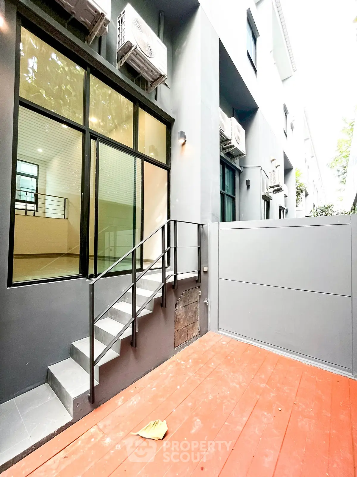 Modern townhouse exterior with sleek design and spacious patio area