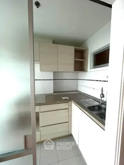 Modern compact kitchen with sleek cabinetry and stainless steel sink