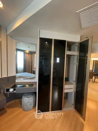 Modern bedroom with sleek wardrobe and stylish vanity area