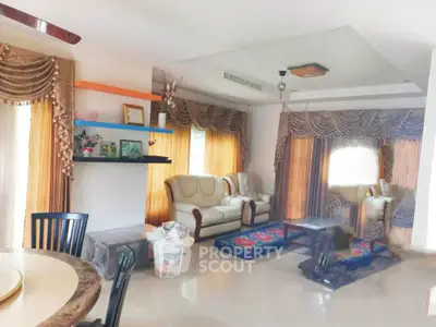 Spacious living room with elegant curtains and comfortable seating