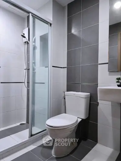 Modern bathroom with sleek shower and elegant gray tiles