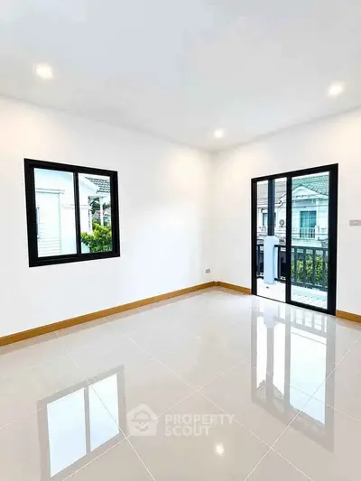 Bright empty room with large windows and glossy tiled floor, perfect for customization.