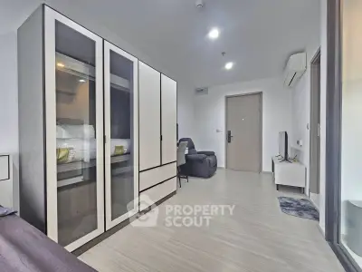Modern living room with sleek furniture and ample storage in a contemporary apartment.