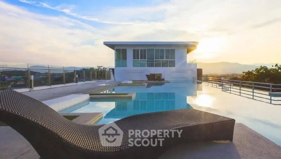 Luxurious rooftop pool with stunning sunset view and modern architecture.