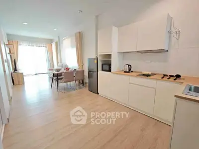 Spacious open-layout kitchen and dining area with modern appliances and natural light.
