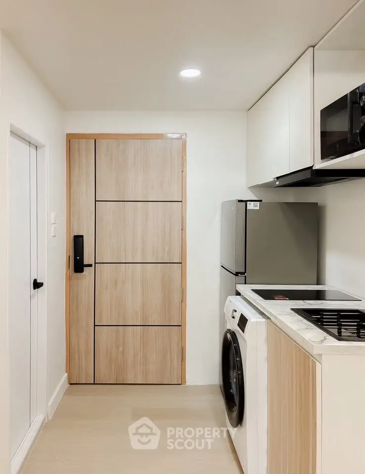 Modern kitchen with sleek appliances and wooden cabinetry