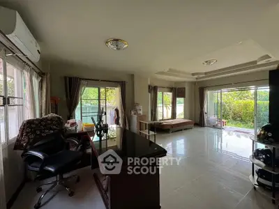 Spacious living room with garden view and modern furnishings