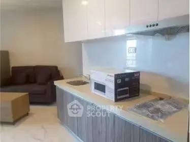 Modern kitchen with sleek cabinetry and cozy living area