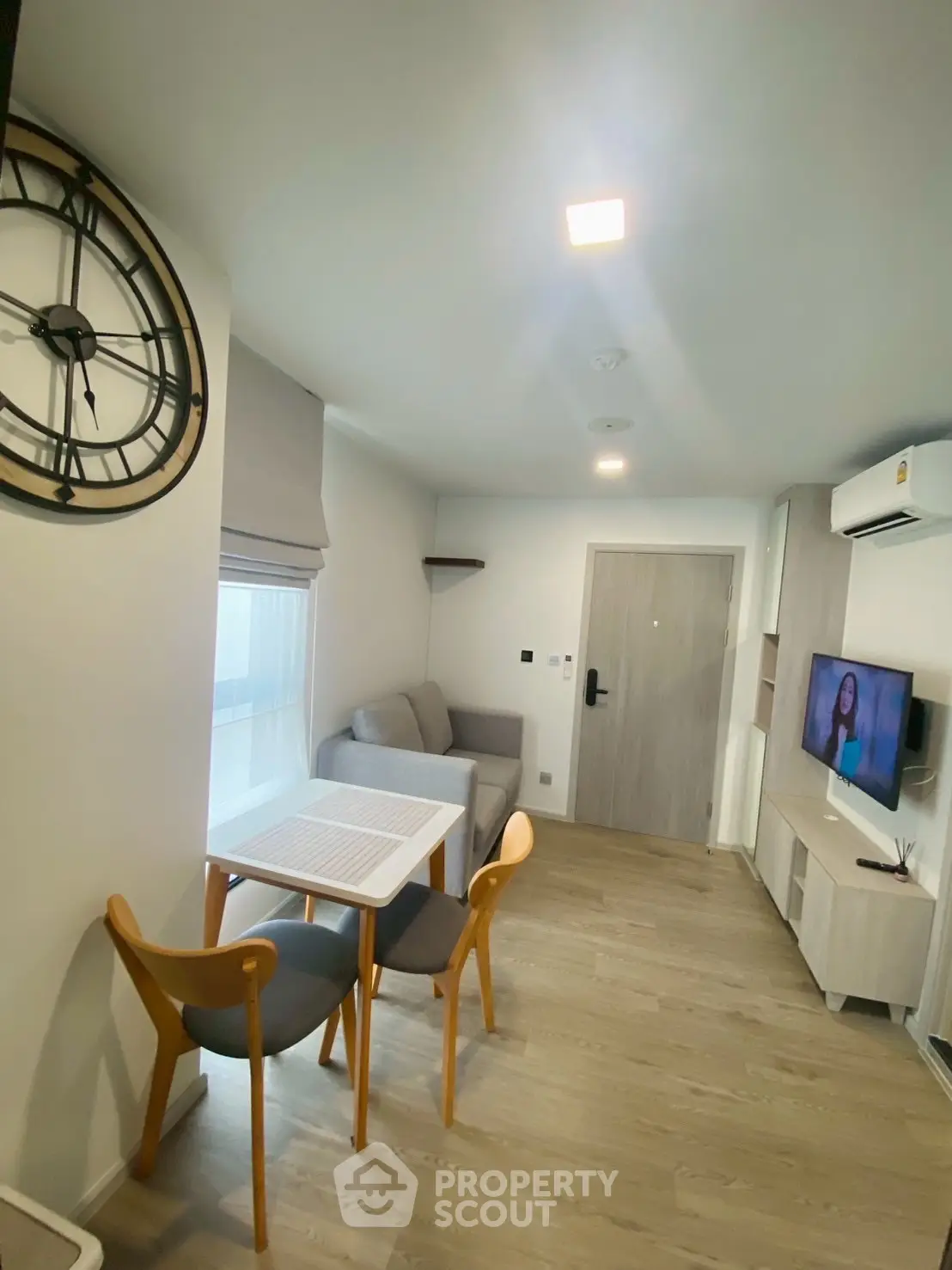 Modern living room with stylish furniture and wall-mounted TV