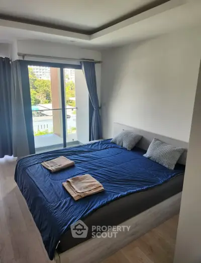 Modern bedroom with large window and pool view, featuring a cozy bed and stylish decor.