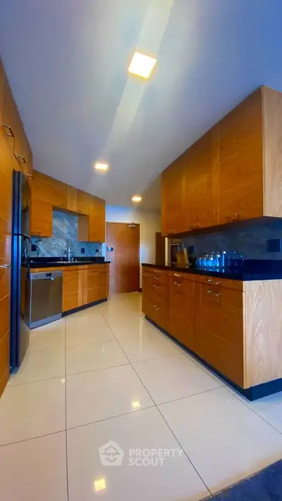 Modern kitchen with sleek wooden cabinets and stainless steel appliances