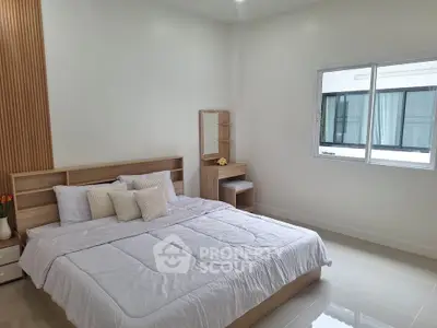 Spacious modern bedroom with natural light and minimalist decor