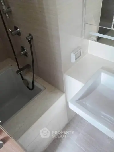Modern bathroom with sleek fixtures and a bathtub, perfect for relaxation.