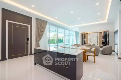 Luxurious open-plan living room with modern kitchen island and elegant decor