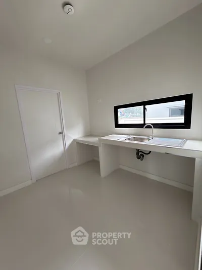 Minimalist kitchen with sleek countertops and modern sink