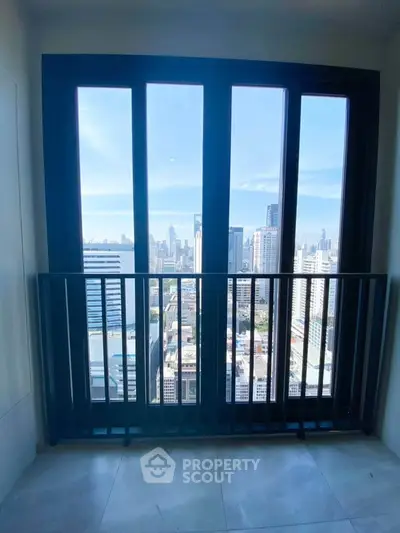 Stunning city view from a modern high-rise balcony with sleek railing.