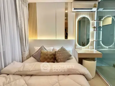 Modern bedroom with stylish decor and mirrored accents in a cozy apartment.