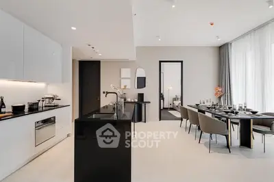 Luxurious open-plan kitchen and dining area with modern design and elegant furnishings.