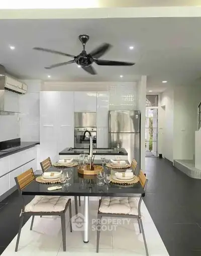 Modern kitchen with sleek appliances and elegant dining setup