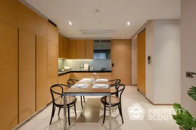 Modern kitchen with sleek wooden cabinetry and dining area