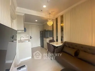 Modern apartment interior with open kitchen and cozy living area featuring elegant lighting.
