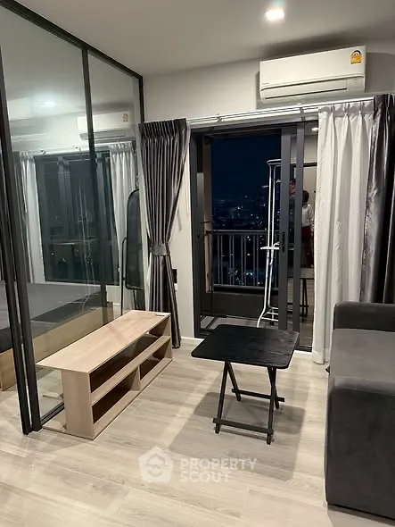 Modern living room with balcony view and sleek glass partitions