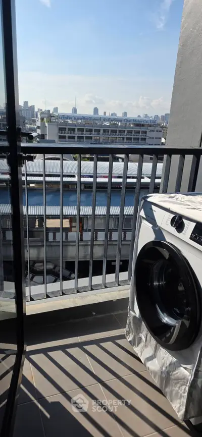 Modern balcony with city view and washing machine, perfect for urban living.