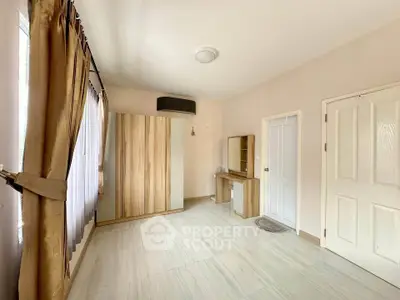 Spacious bedroom with modern wardrobe and natural light