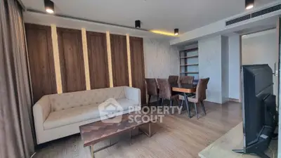 Modern living room with elegant wood paneling and stylish furniture