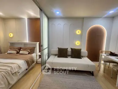 Modern bedroom with stylish decor and cozy seating area
