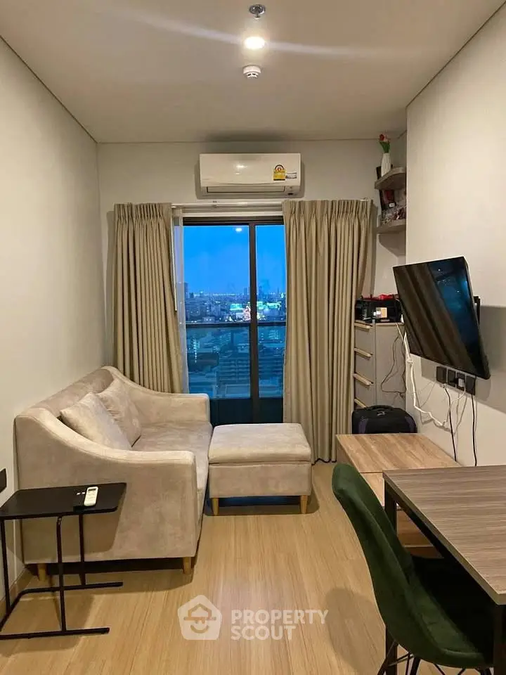 Cozy living room with city view, modern furniture, and wall-mounted TV.
