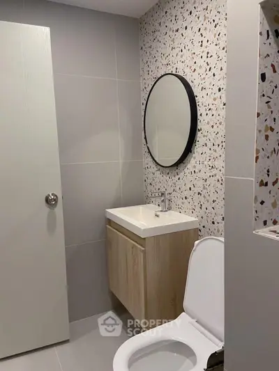 Modern bathroom with terrazzo wall and sleek fixtures