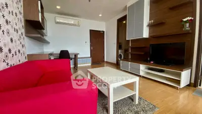 Modern living room with red sofa, TV unit, and wooden flooring in a stylish apartment.