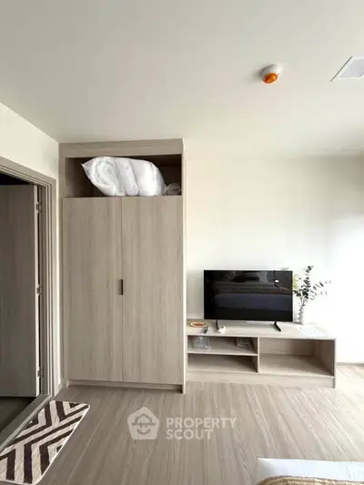Modern bedroom with built-in wardrobe and sleek TV stand