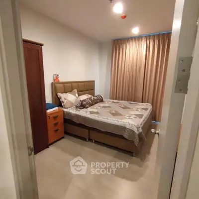 Cozy bedroom with stylish decor and ample natural light