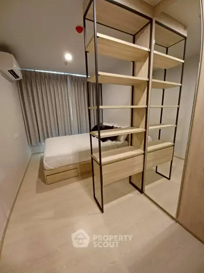 Modern bedroom with stylish shelving and cozy ambiance