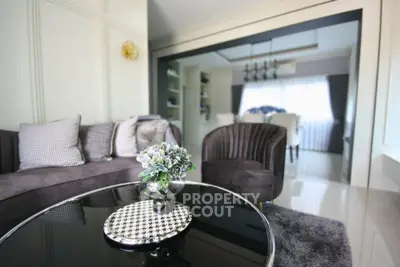 Elegant living room with modern decor and plush seating