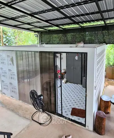 Unique outdoor storage unit with sliding glass door and covered roof