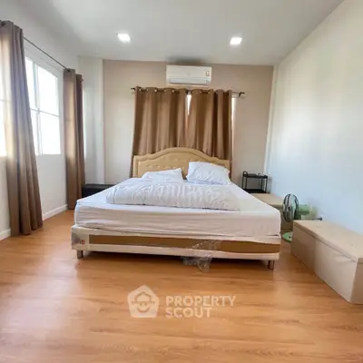 Spacious bedroom with elegant decor and natural light