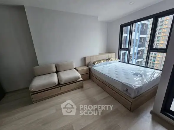 Modern bedroom with large windows and stylish furniture in urban apartment