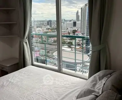 Stunning city view from a modern bedroom with large window and cozy bed.