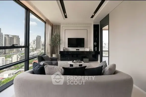 Luxurious modern living room with panoramic city views and elegant furnishings.