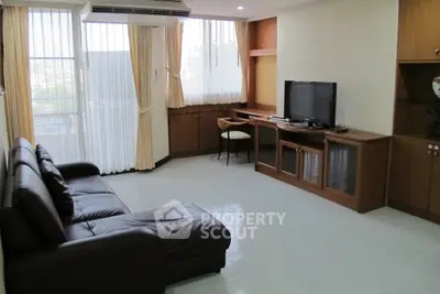 Spacious living room with modern furniture and large windows for natural light.
