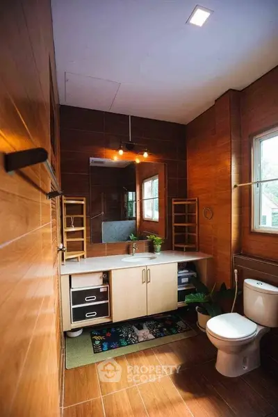 Modern bathroom with wooden accents, sleek vanity, and natural light from window.